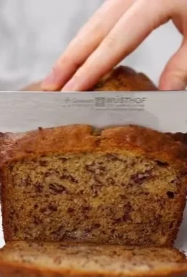 Homemade banana bread sliced on a wooden board