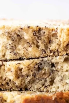 Deliciously moist banana bread loaf on a wooden cutting board