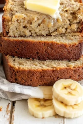 Freshly baked easy banana bread loaf on a wooden table