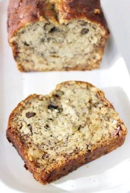 Moist banana bread loaf fresh out of the oven, sliced and ready to serve