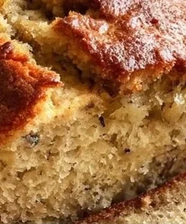 Moist banana bread made with 3 ripe bananas on a wooden cutting board