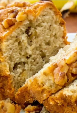 Moist banana bread with toasted walnuts served on a plate
