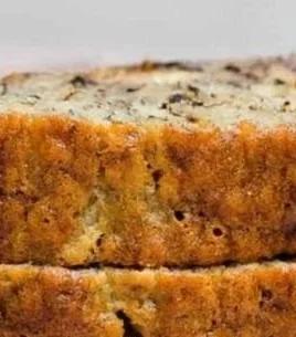 Delicious slice of Paula Deen's banana nut bread on a wooden cutting board
