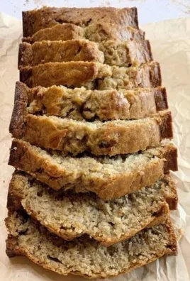 Loaf of perfectly baked banana nut bread with walnuts