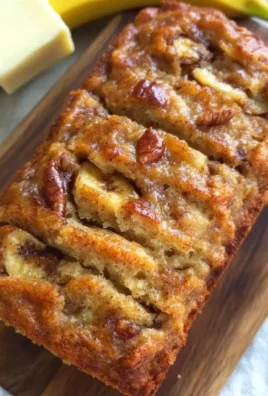 Loaf of the world's best banana bread on a wooden table.