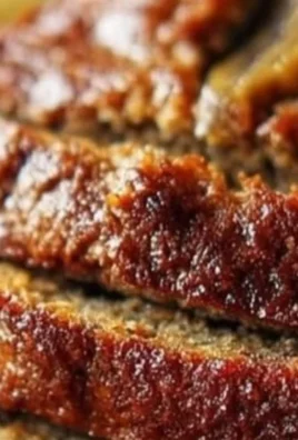 Slice of ultimate moist banana bread on a wooden table