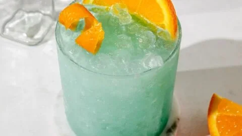 Blue Hawaiian Mocktail drink served in a vibrant glass with tropical garnishes.