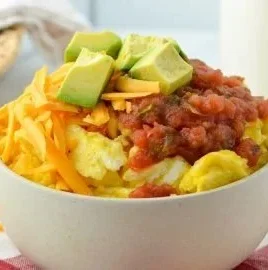Delicious breakfast burrito bowl with eggs, beans, and fresh veggies.