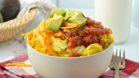 Delicious breakfast burrito bowl with eggs, beans, and fresh veggies.