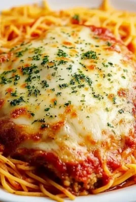 Delicious Chicken Parmesan served with pasta and marinara sauce
