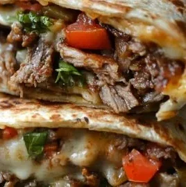 Crispy Philly cheesesteak grilled wraps with melted cheese and steak filling