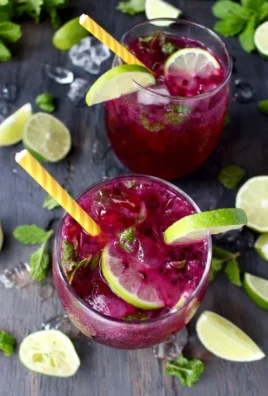 Refreshing Dragon Fruit Juice Mojito served in a glass with mint leaves.