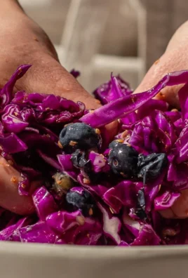 Fermented blueberry sauerkraut made with red cabbage and coriander in a jar