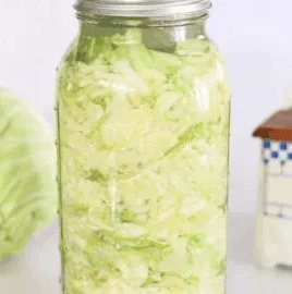 Homemade fermented sauerkraut in a jar, showcasing its vibrant colors and texture.
