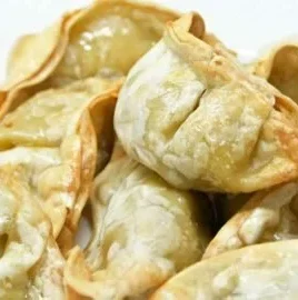 Frozen potstickers cooked in an air fryer, golden and crispy.