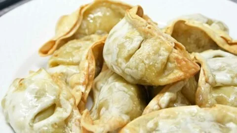 Frozen potstickers cooked in an air fryer, golden and crispy.