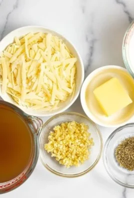 Creamy garlic parmesan sauce drizzled over pasta, garlic, and herbs
