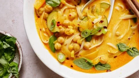 Bowl of gut-friendly Thai noodle soup with fresh herbs and spices