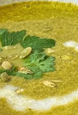 A bowl of healthy green soup made with fresh vegetables and herbs.