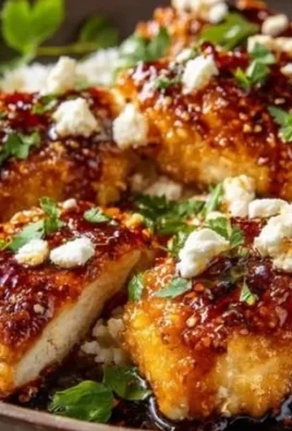 Hot Honey Feta Chicken served on a plate with herbs and spices