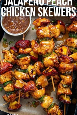 Jalapeno peach chicken skewers served on a grill platter