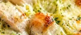 Keto Chicken Alfredo Cabbage Bake topped with cheese and herbs
