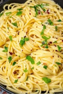 Bowl of Lemon Butter Garlic Pasta Sauce garnished with herbs