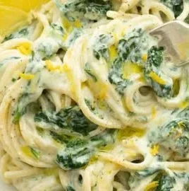 Lemon ricotta pasta with spinach topped with parmesan cheese