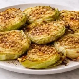 Oven roasted garlic cabbage steaks served on a plate