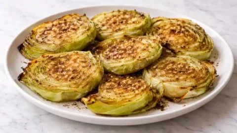 Oven roasted garlic cabbage steaks served on a plate