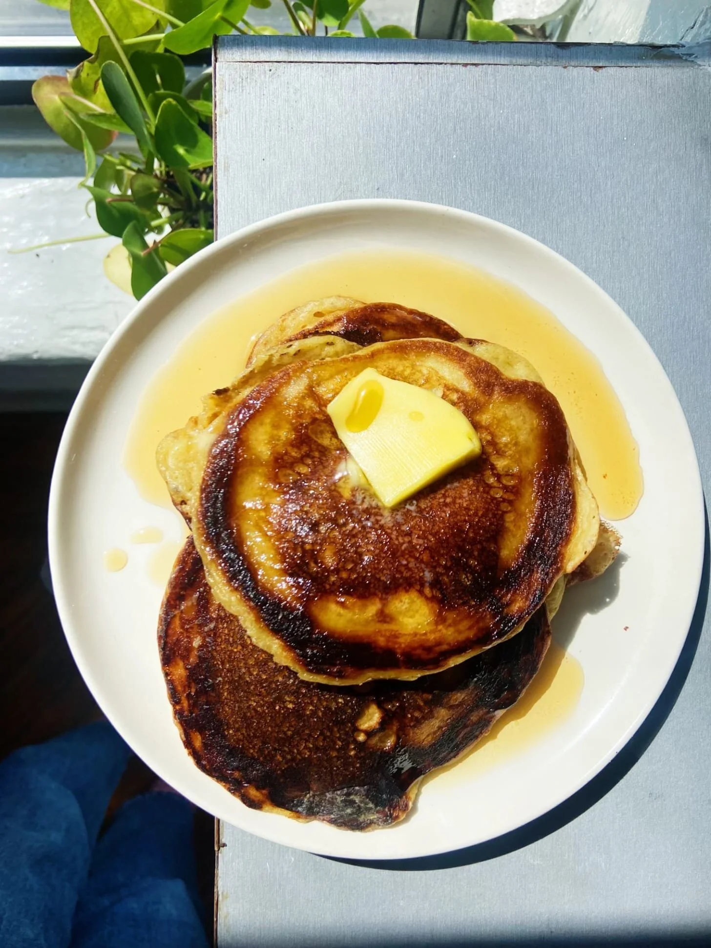 Plate of perfect crispy pancakes with syrup and berries