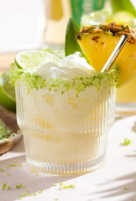 Refreshing Pineapple Coconut Margarita in a glass with fresh pineapple