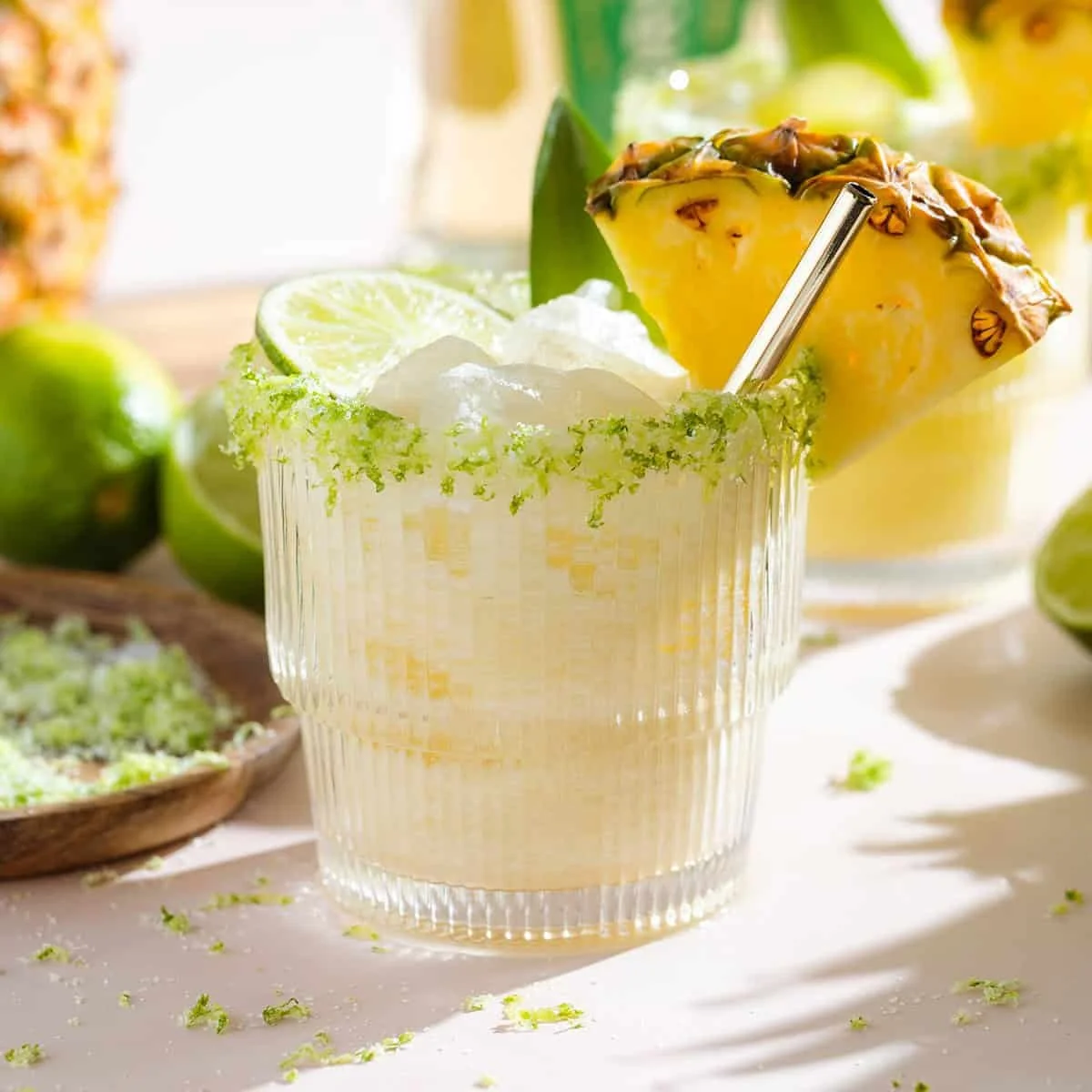 Refreshing Pineapple Coconut Margarita in a glass with fresh pineapple