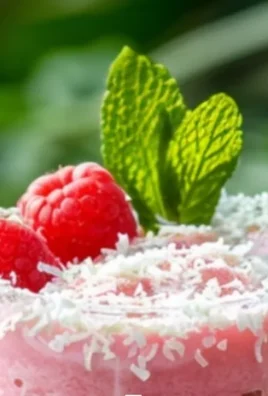 Raspberry Coconut Mojito cocktail garnished with fresh mint and raspberries.