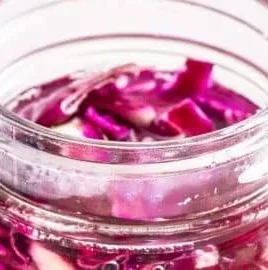 Jar of homemade red cabbage sauerkraut with vibrant color and texture