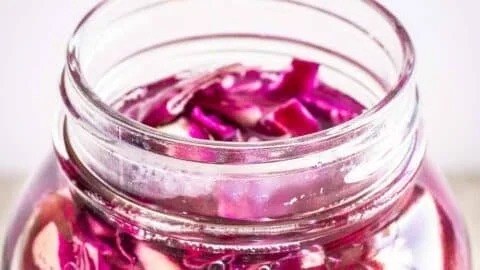 Jar of homemade red cabbage sauerkraut with vibrant color and texture