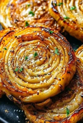 Tasty roasted cabbage steaks served with seasoning and herbs