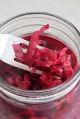 Homemade sauerkraut in a jar, promoting gut health through fermentation.
