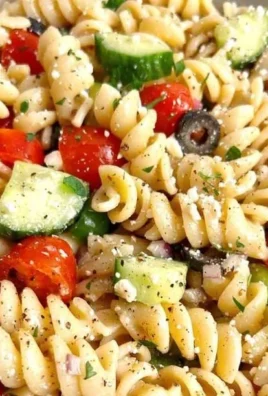 Delicious pasta salad with Italian dressing, fresh vegetables, and vibrant colors.