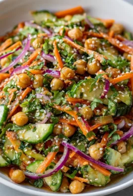 Asian cucumber and chickpea slaw with sesame dressing in a bowl.