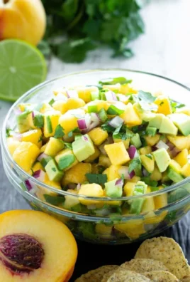 Bowl of Avocado Peach Salsa with fresh ingredients and colorful presentation