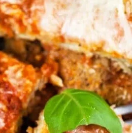 Baked gluten-free eggplant parmesan garnished with fresh basil