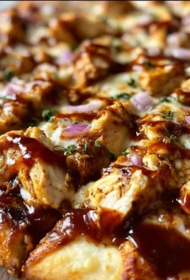 BBQ Chicken Pizza topped with chicken, barbecue sauce, and fresh vegetables