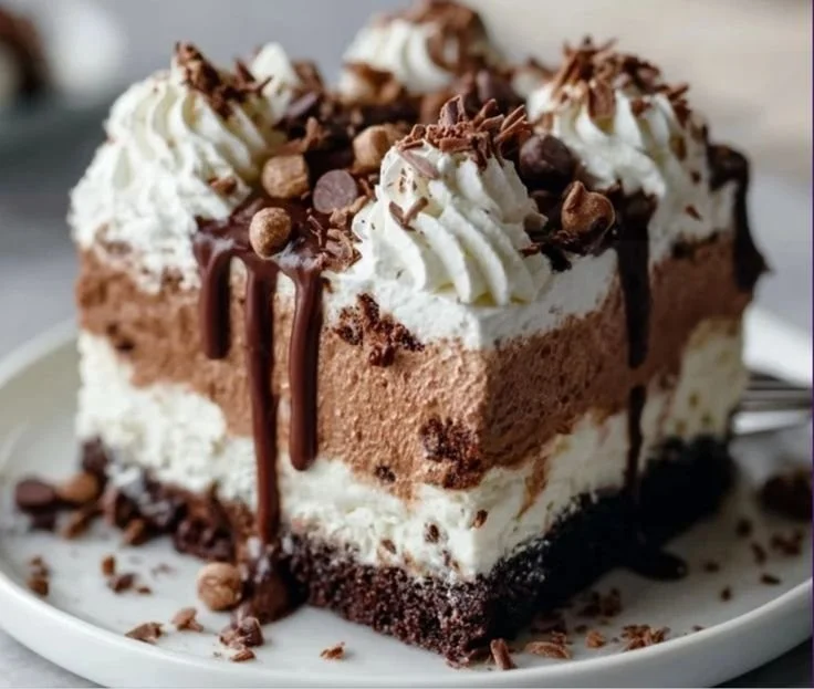 Delicious Brownie Refrigerator Cake topped with chocolate and whipped cream