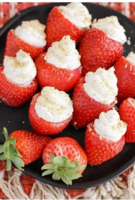 Delicious cheesecake stuffed strawberries on a white plate