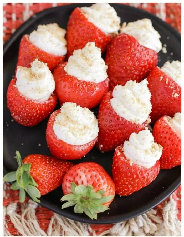 Delicious cheesecake stuffed strawberries on a white plate