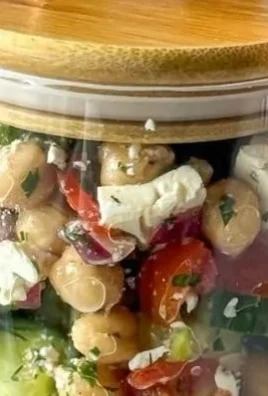 Chickpea cucumber salad served in a bowl with colorful vegetables.