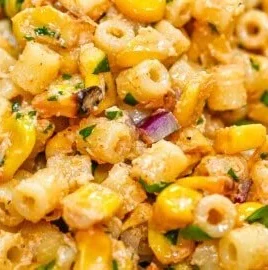 Colorful corn elote pasta salad with toppings and dressing