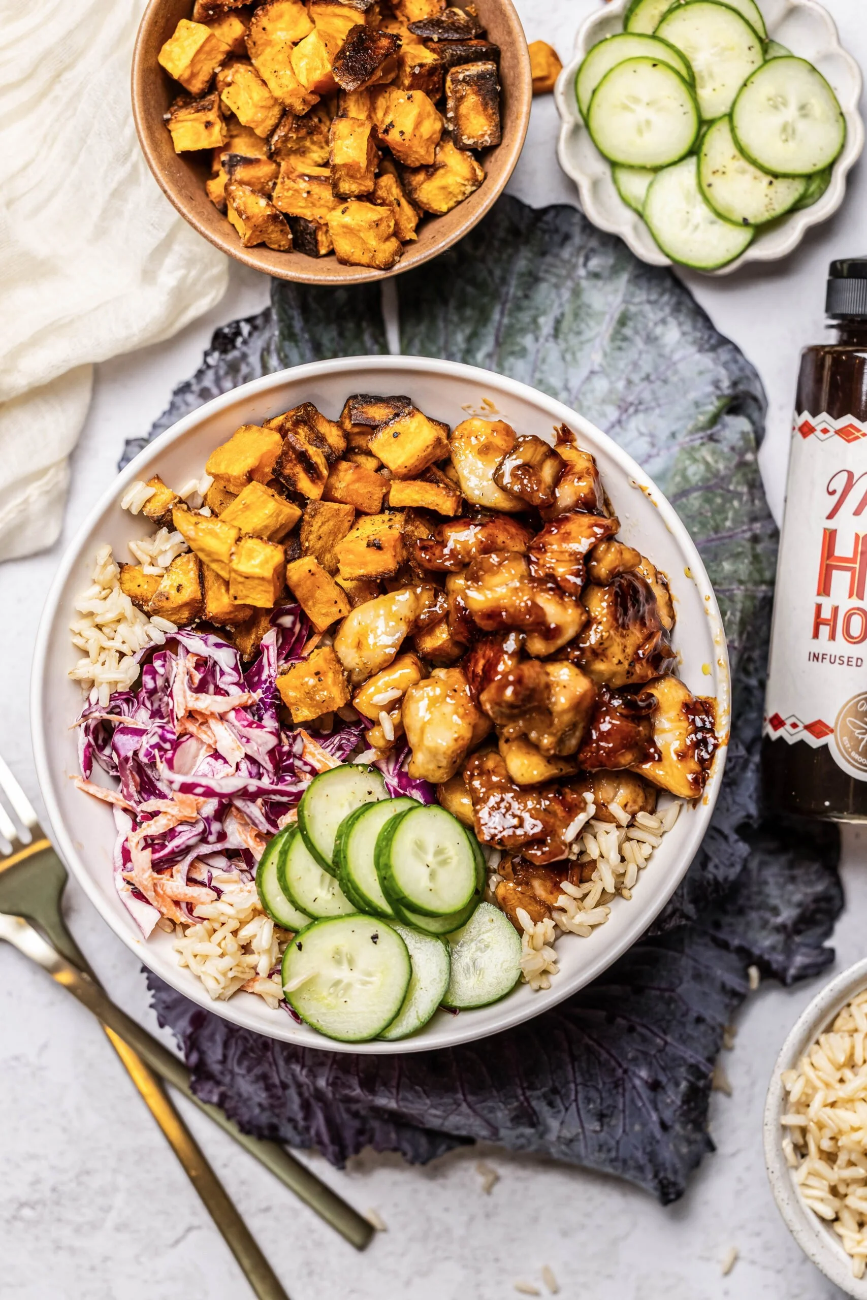 Healthy hot honey chicken bowls with fresh vegetables and rice
