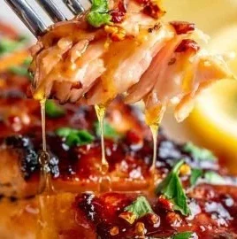 Grilled hot honey salmon drizzled with spicy honey glaze on a plate.